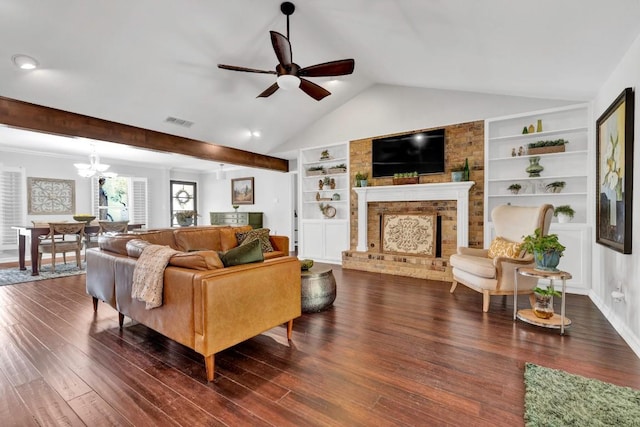 4001 Greystone Dr, Austin, TX 78731 - living area with a brick fireplace, a ceiling fan, vaulted ceiling, built in shelves, and dark wood finished floors