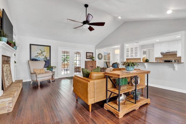 4001 Greystone Dr, Austin, TX 78731 - living area with ceiling fan, dark wood-type flooring, a fireplace with raised hearth, high vaulted ceiling, and french doors