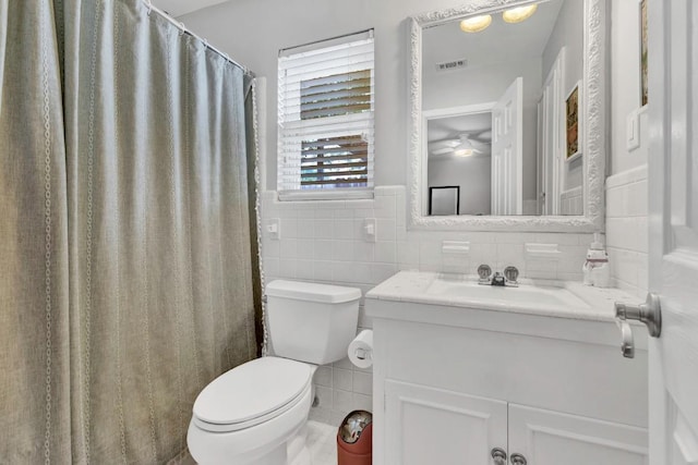 4001 Greystone Dr, Austin, TX 78731 - bathroom with tile walls, vanity, ceiling fan, and wainscoting