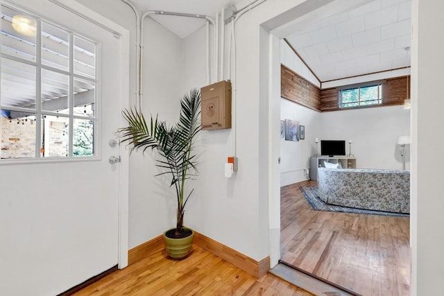 4001 Greystone Dr, Austin, TX 78731 - hallway featuring wood finished floors, healthy amount of natural light, and vaulted ceiling
