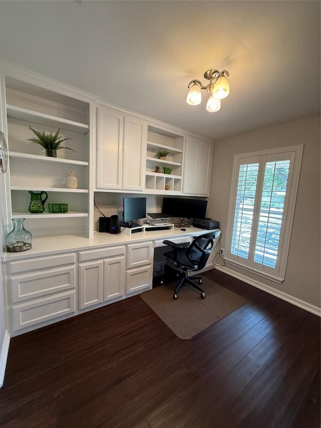 4001 Greystone Dr, Austin, TX 78731 - office space featuring built in study area, dark wood-style floors, and a chandelier