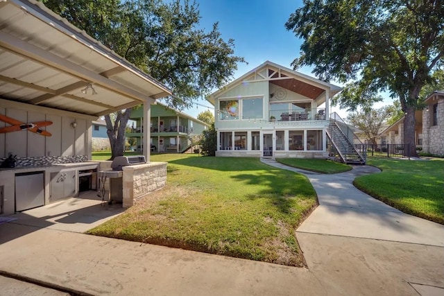 136 Web Isle Dr, Granite Shoals, TX 78654 - view of front facade featuring stairs, a front yard, board and batten siding, and a balcony
