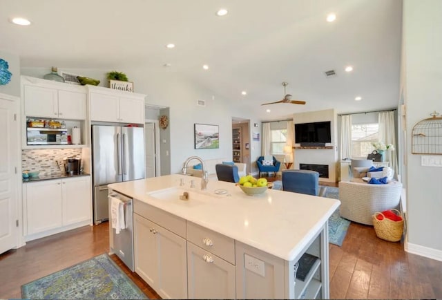 136 Web Isle Dr, Granite Shoals, TX 78654 - kitchen with appliances with stainless steel finishes, dark wood-style flooring, white cabinetry, a ceiling fan, and an island with sink