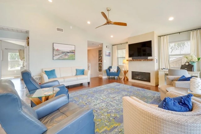 136 Web Isle Dr, Granite Shoals, TX 78654 - living area featuring a ceiling fan, a glass covered fireplace, wood finished floors, vaulted ceiling, and recessed lighting