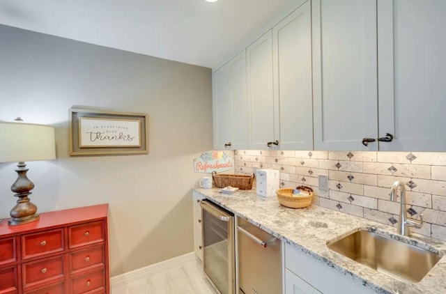 136 Web Isle Dr, Granite Shoals, TX 78654 - kitchen with wine cooler, tasteful backsplash, light stone counters, and white cabinetry