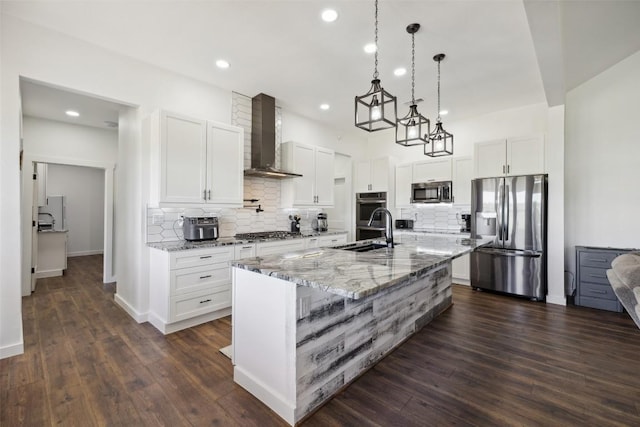 105 Mesa Grande Ct, Marble Falls, TX 78654 - kitchen with stainless steel appliances, wall chimney exhaust hood, recessed lighting, decorative backsplash, and light stone countertops