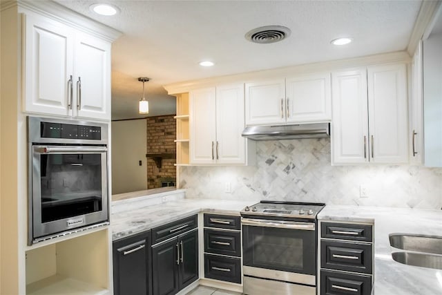 215 Edward Ln, Brenham, TX 77833 - kitchen featuring appliances with stainless steel finishes, under cabinet range hood, dark cabinets, white cabinets, and open shelves