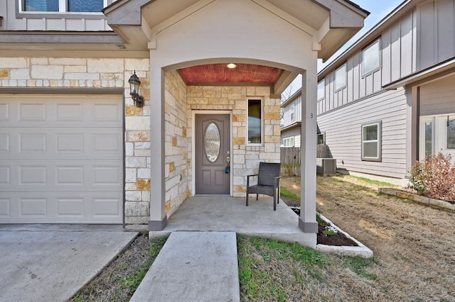 3303 Elija St Unit A & B, Austin, TX 78745 - property entrance with stone siding, board and batten siding, and a garage
