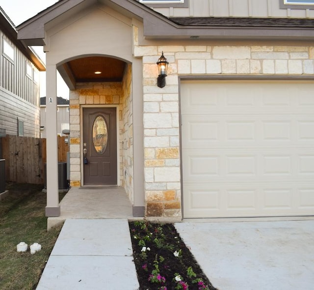 3303 Elija St Unit A & B, Austin, TX 78745 - view of exterior entry with stone siding and a garage
