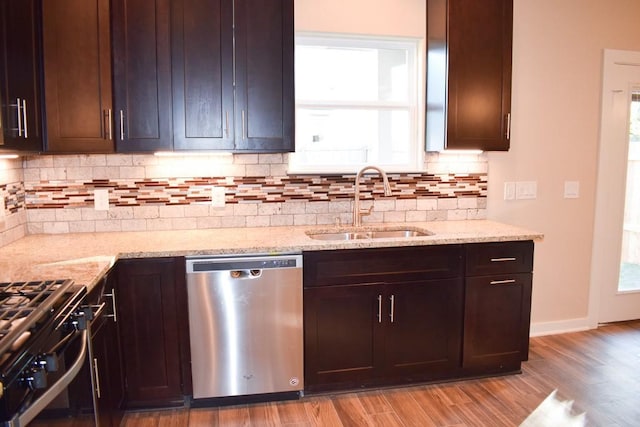 3303 Elija St Unit A & B, Austin, TX 78745 - kitchen with dishwasher, light wood-style flooring, gas range oven, decorative backsplash, and light stone countertops