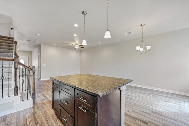 3303 Elija St Unit A & B, Austin, TX 78745 - kitchen with ceiling fan, a chandelier, light wood-style flooring, open floor plan, and recessed lighting