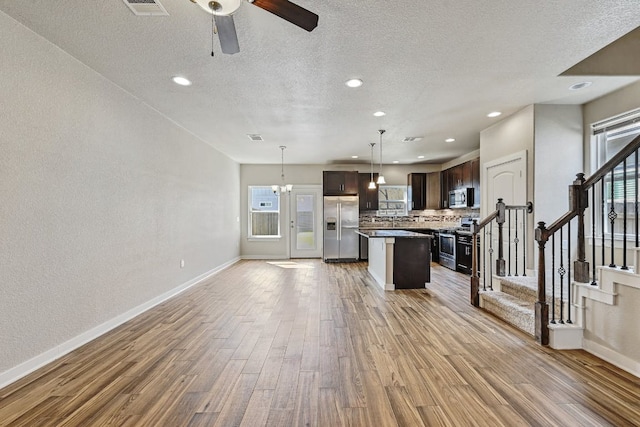 3303 Elija St Unit A & B, Austin, TX 78745 - kitchen featuring appliances with stainless steel finishes, light wood-style flooring, plenty of natural light, a textured ceiling, and recessed lighting