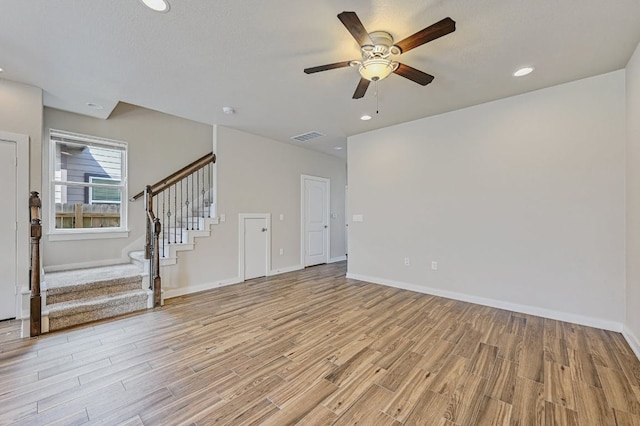 3303 Elija St Unit A & B, Austin, TX 78745 - unfurnished living room with light wood-style floors, a ceiling fan, stairs, and recessed lighting