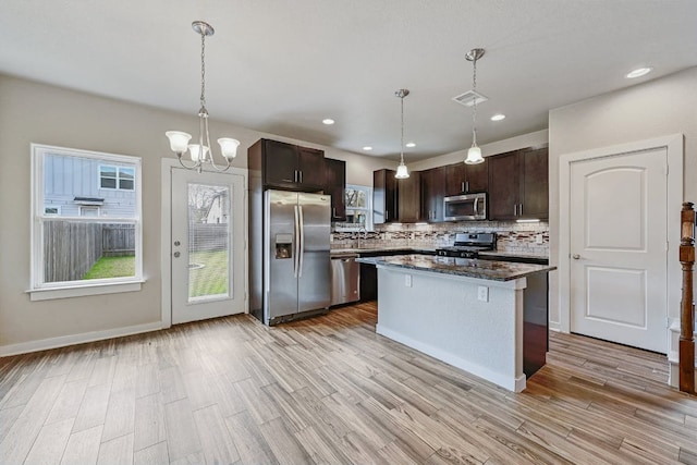 3303 Elija St Unit A & B, Austin, TX 78745 - kitchen featuring stainless steel appliances, tasteful backsplash, dark brown cabinetry, light wood-style flooring, and recessed lighting