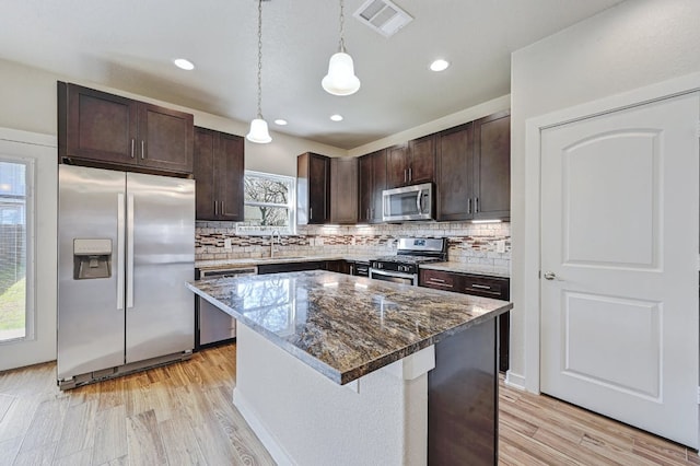 3303 Elija St Unit A & B, Austin, TX 78745 - kitchen with stainless steel appliances, light wood-style flooring, dark brown cabinetry, backsplash, and recessed lighting