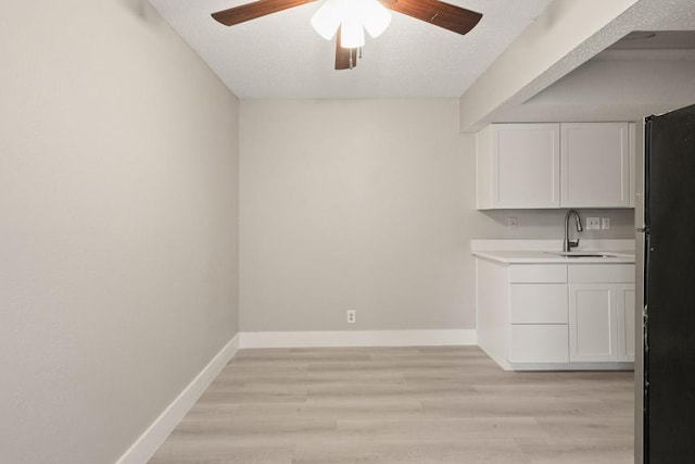 2600 Penny Ln Unit 115, Austin, TX 78757 - unfurnished dining area featuring a ceiling fan, light wood finished floors, and a textured ceiling