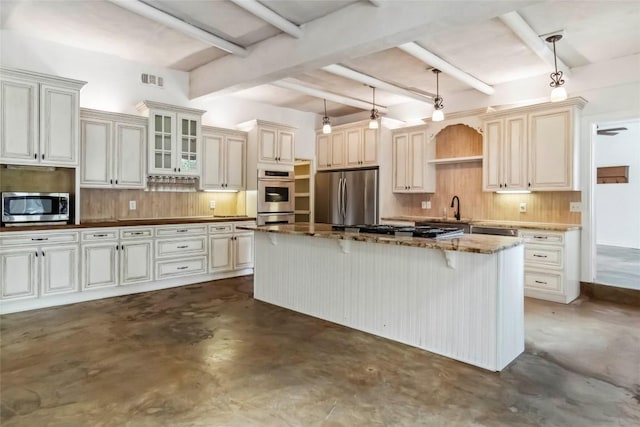 208 Old Potato Rd, Paige, TX 78659 - kitchen featuring appliances with stainless steel finishes, finished concrete floors, decorative backsplash, beamed ceiling, and a kitchen island
