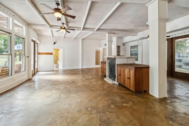 208 Old Potato Rd, Paige, TX 78659 - kitchen featuring concrete floors, ornate columns, ceiling fan, open floor plan, and beam ceiling