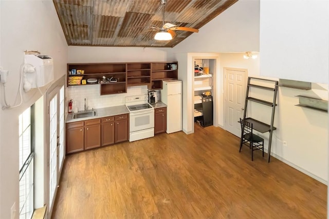 208 Old Potato Rd, Paige, TX 78659 - kitchen featuring white appliances, open shelves, vaulted ceiling, wood finished floors, and backsplash
