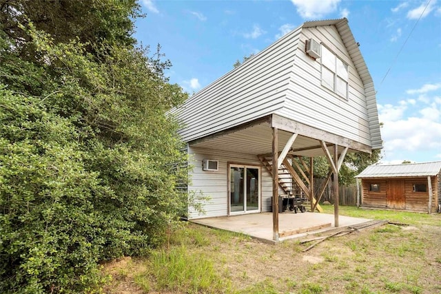 208 Old Potato Rd, Paige, TX 78659 - back of property with stairway, a patio area, an outbuilding, and a wall mounted AC