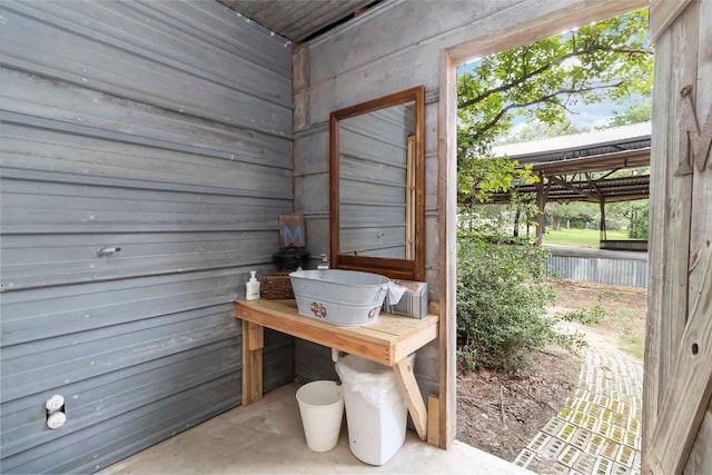208 Old Potato Rd, Paige, TX 78659 - doorway to outside with unfinished concrete floors, a relaxing sauna, and wooden walls