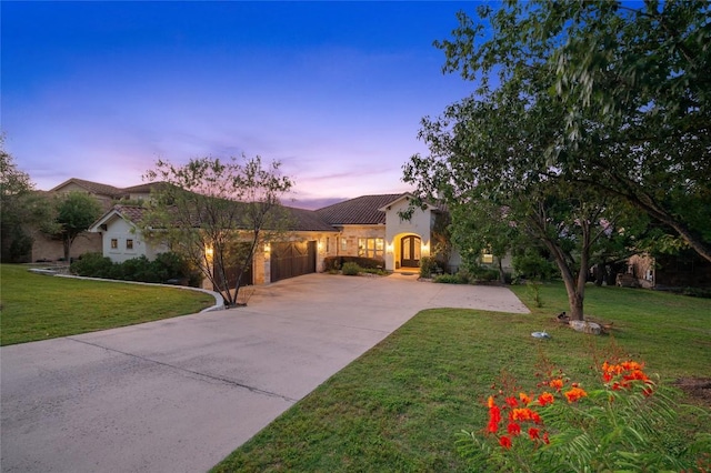 3810 Pawnee Pass, Austin, TX 78738 - mediterranean / spanish home featuring an attached garage, driveway, a front yard, stucco siding, and a tile roof
