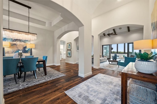 3810 Pawnee Pass, Austin, TX 78738 - foyer featuring ceiling fan, wood finished floors, beam ceiling, arched walkways, and a high ceiling