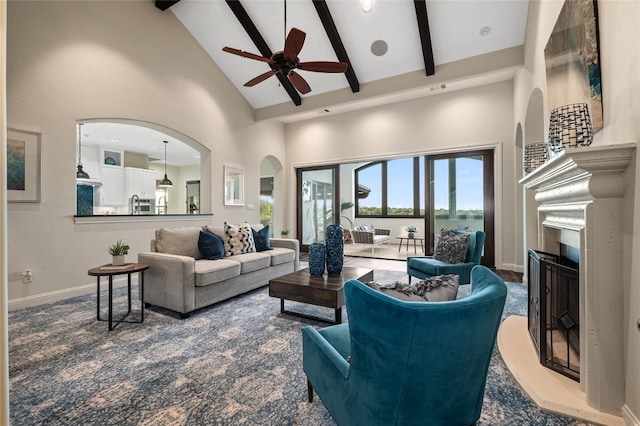 3810 Pawnee Pass, Austin, TX 78738 - living room with high vaulted ceiling, a fireplace, beamed ceiling, ceiling fan, and arched walkways