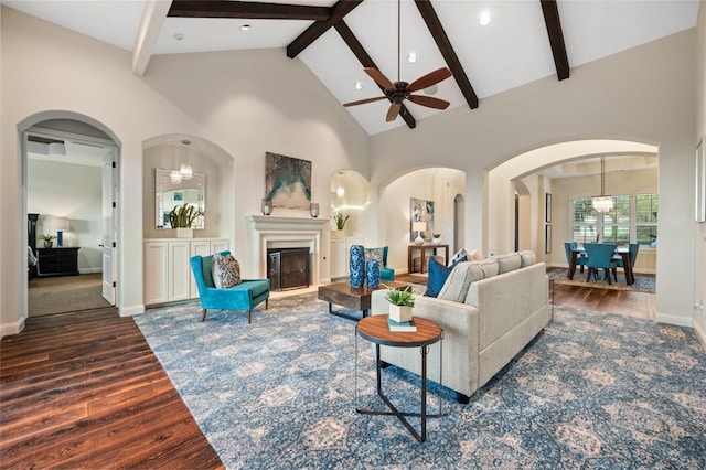 3810 Pawnee Pass, Austin, TX 78738 - living room featuring wood finished floors, ceiling fan, high vaulted ceiling, beamed ceiling, and a glass covered fireplace