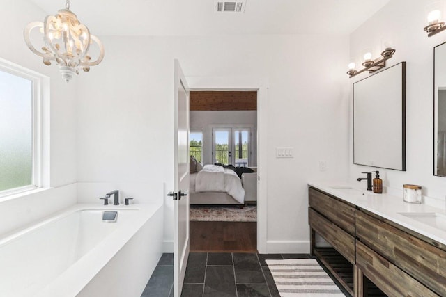 169 Tall Forest Dr, Bastrop, TX 78602 - ensuite bathroom with double vanity, a bath, tile patterned floors, and a chandelier