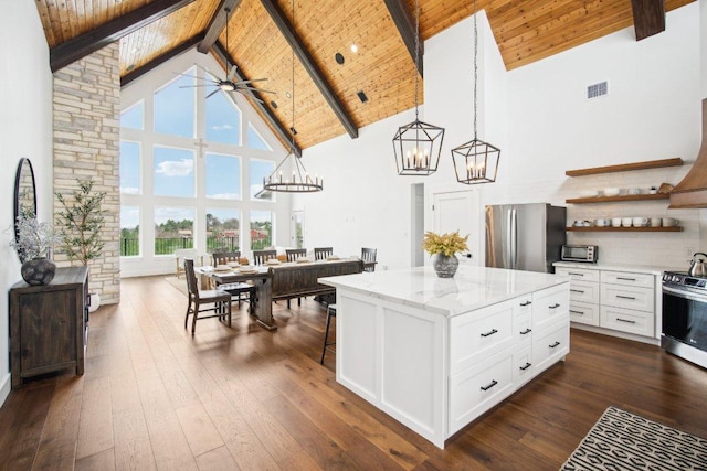 169 Tall Forest Dr, Bastrop, TX 78602 - kitchen with stainless steel appliances, high vaulted ceiling, a chandelier, open shelves, and a wood ceiling with exposed beams