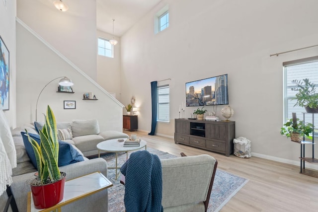 3526 Wickham Ln, Austin, TX 78725 - living room featuring stairway, wood finished floors, and a high ceiling