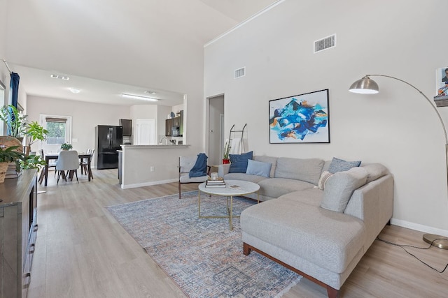 3526 Wickham Ln, Austin, TX 78725 - living area with light wood-style floors and a high ceiling
