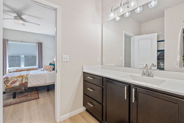 3526 Wickham Ln, Austin, TX 78725 - ensuite bathroom with wood finished floors, vanity, and ceiling fan