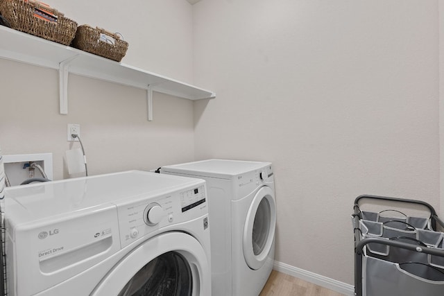 3526 Wickham Ln, Austin, TX 78725 - washroom featuring separate washer and dryer and light wood-type flooring