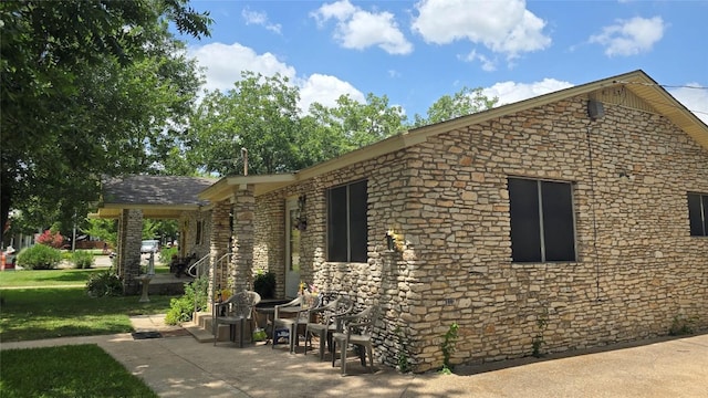 1801 Ash St, Georgetown, TX 78626 - view of home's exterior with stone siding and a lawn