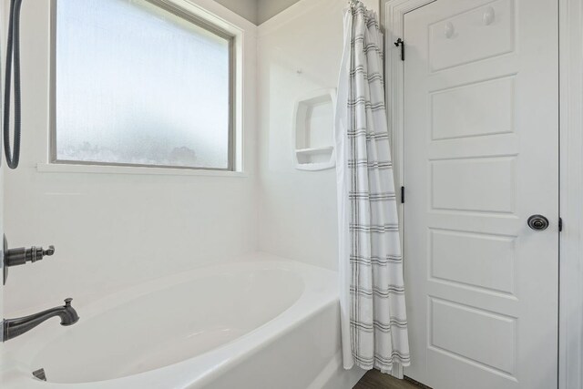 103 W Tomlinson St, Florence, TX 76527 - bathroom with a bathtub and a shower with shower curtain