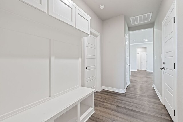 103 W Tomlinson St, Florence, TX 76527 - mudroom with baseboards and wood finished floors