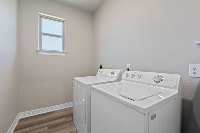 103 W Tomlinson St, Florence, TX 76527 - laundry room with washing machine and clothes dryer and wood finished floors