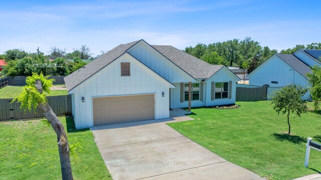 103 W Tomlinson St, Florence, TX 76527 - view of front of property with a shingled roof, a garage, driveway, and board and batten siding