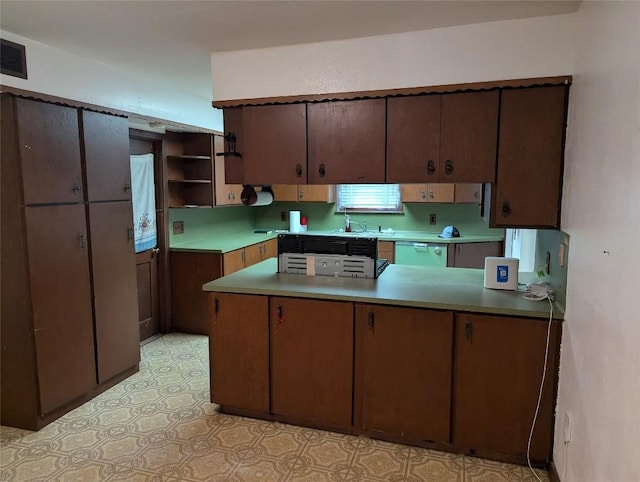 606 Scurry St, Austin, TX 78753 - kitchen featuring open shelves, a peninsula, light flooring, light countertops, and dishwashing machine