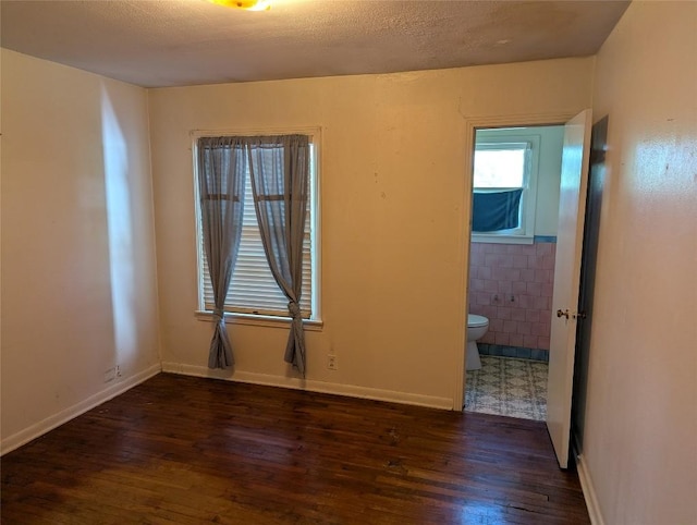 606 Scurry St, Austin, TX 78753 - unfurnished room with wood finished floors and tile walls
