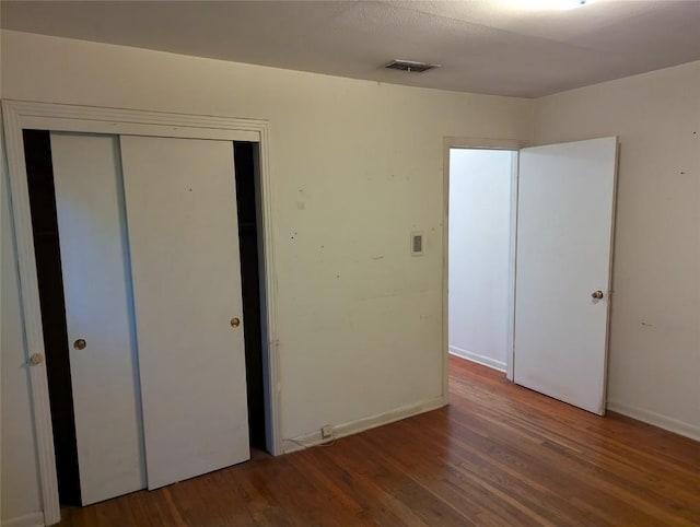 606 Scurry St, Austin, TX 78753 - unfurnished bedroom with wood finished floors and a closet