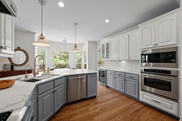 707 Malabar St, Lakeway, TX 78734 - kitchen with gray cabinetry, stainless steel appliances, wine cooler, white cabinetry, and recessed lighting