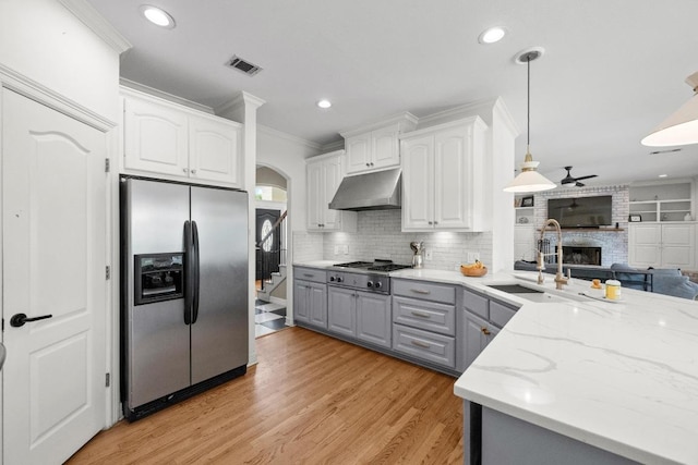 707 Malabar St, Lakeway, TX 78734 - kitchen featuring appliances with stainless steel finishes, gray cabinetry, under cabinet range hood, ornamental molding, and ceiling fan