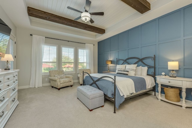 2800 Crystal Falls Pkwy, Leander, TX 78641 - bedroom featuring light carpet, a decorative wall, a ceiling fan, a tray ceiling, and a wooden ceiling with exposed beams