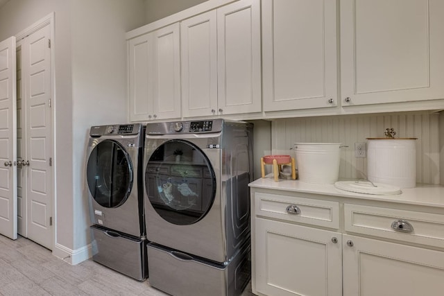 2800 Crystal Falls Pkwy, Leander, TX 78641 - laundry room with washer and clothes dryer, cabinet space, and light wood finished floors