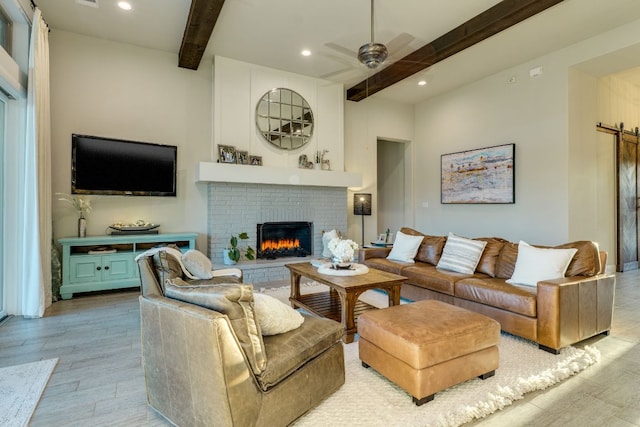 2800 Crystal Falls Pkwy, Leander, TX 78641 - living room with beamed ceiling, a brick fireplace, light wood-style flooring, recessed lighting, and ceiling fan