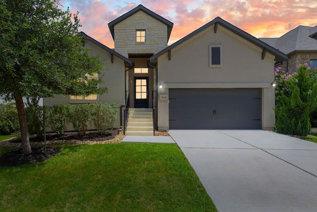 3604 Mercer Rd, Georgetown, TX 78628 - french provincial home with driveway, a front lawn, stucco siding, stone siding, and an attached garage