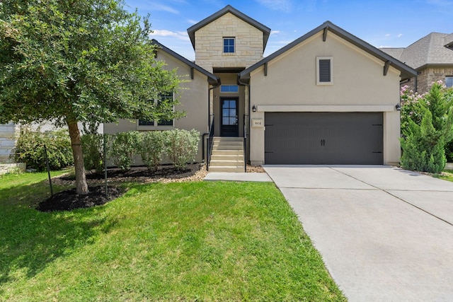3604 Mercer Rd, Georgetown, TX 78628 - view of front of house featuring driveway, a front yard, stucco siding, a garage, and stone siding